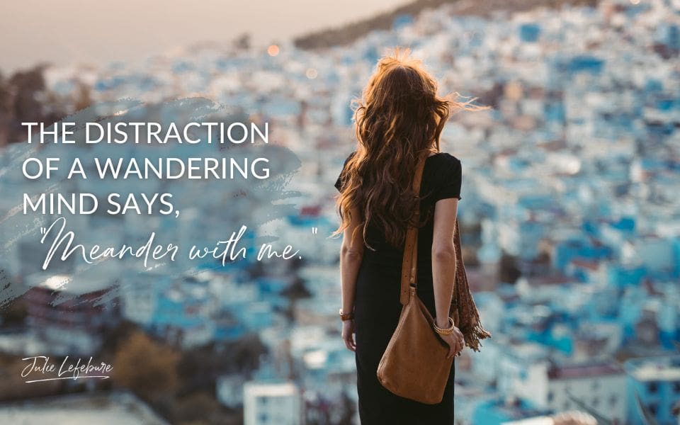 The Distraction of a Wandering Mind Says, "Meander with Me" | woman in dress with purse overlooking a city