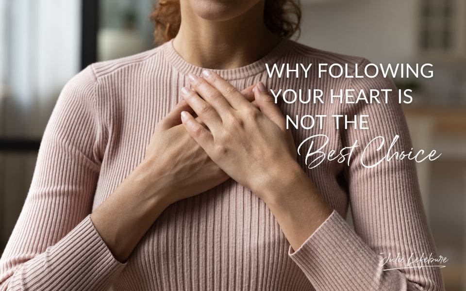 Why Following Your Heart Is Not the Best Choice | woman in blush colored sweater with hands crossed over heart