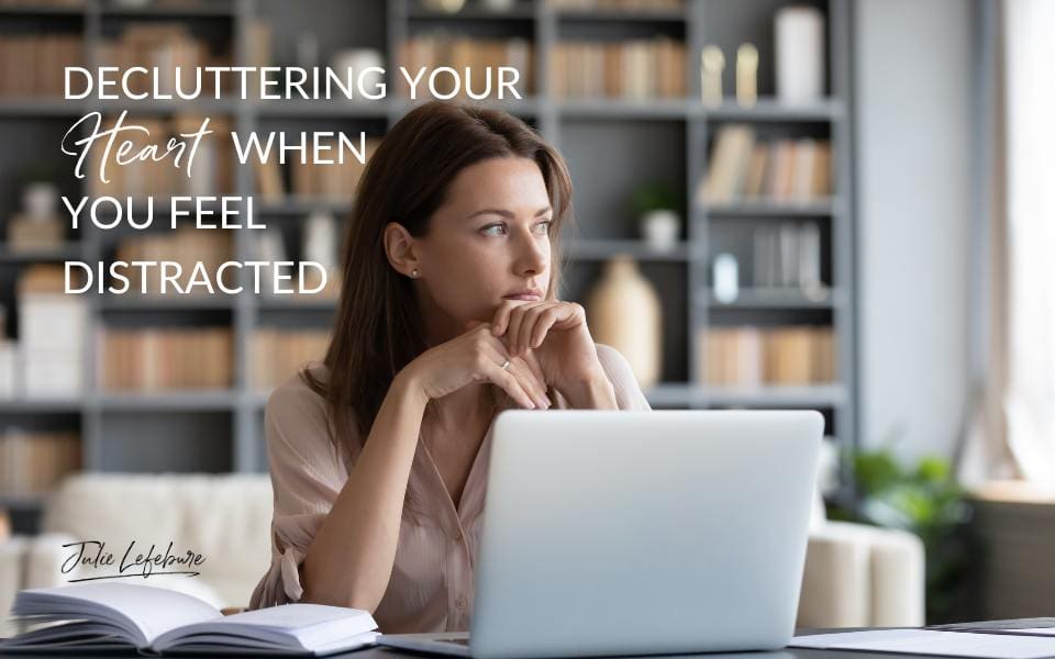 Decluttering Your Heart When You Feel Distracted | woman at sitting with laptop on desk as she stares off to the side