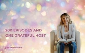 200 Episodes and One Grateful Host | Julie Lefebure sitting on a chair with Bible open on lap